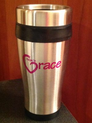 These 16 oz. black insulated stainless steel travel mugs come with the Hope in Grace logo imprinted on both sides in a magenta color. With stainless steel outer walls and double wall plastic insulated inner liner, smooth curved body for easy grasp and spill proof plastic lids with slide locks, these will soon become the to-go-to in the safe transport of your beverages. These mugs are available for purchase on our website for $10 or you can buy yours at our event on April 26th and receive it FULL of Caribou coffee!