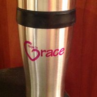 These 16 oz. black insulated stainless steel travel mugs come with the Hope in Grace logo imprinted on both sides in a magenta color. With stainless steel outer walls and double wall plastic insulated inner liner, smooth curved body for easy grasp and spill proof plastic lids with slide locks, these will soon become the to-go-to in the safe transport of your beverages. These mugs are available for purchase on our website for $10 or you can buy yours at our event on April 26th and receive it FULL of Caribou coffee!